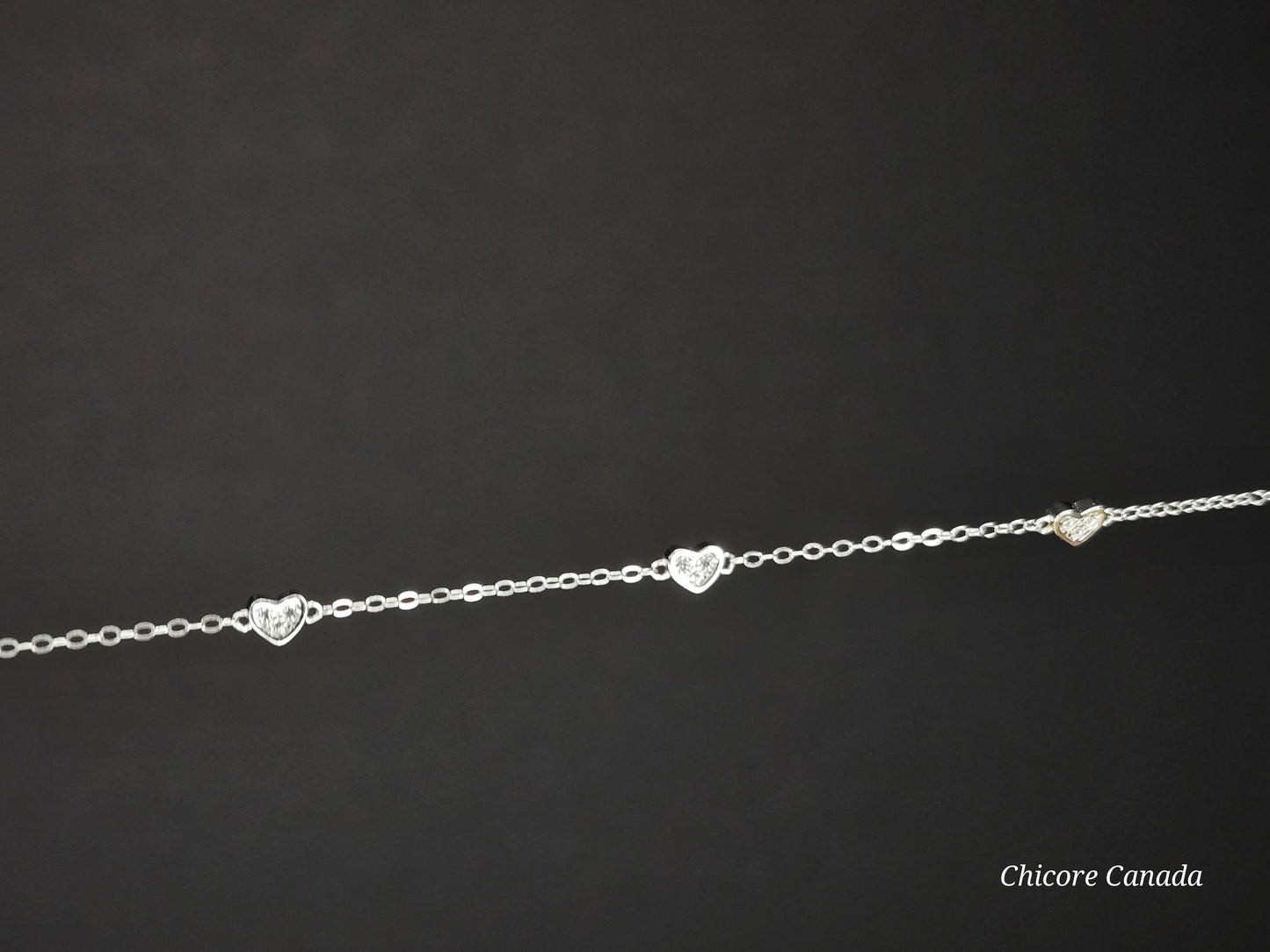Sterling Silver Adjustable Bracelet with Three Dazzling Cubic Zirconia Heart Charms