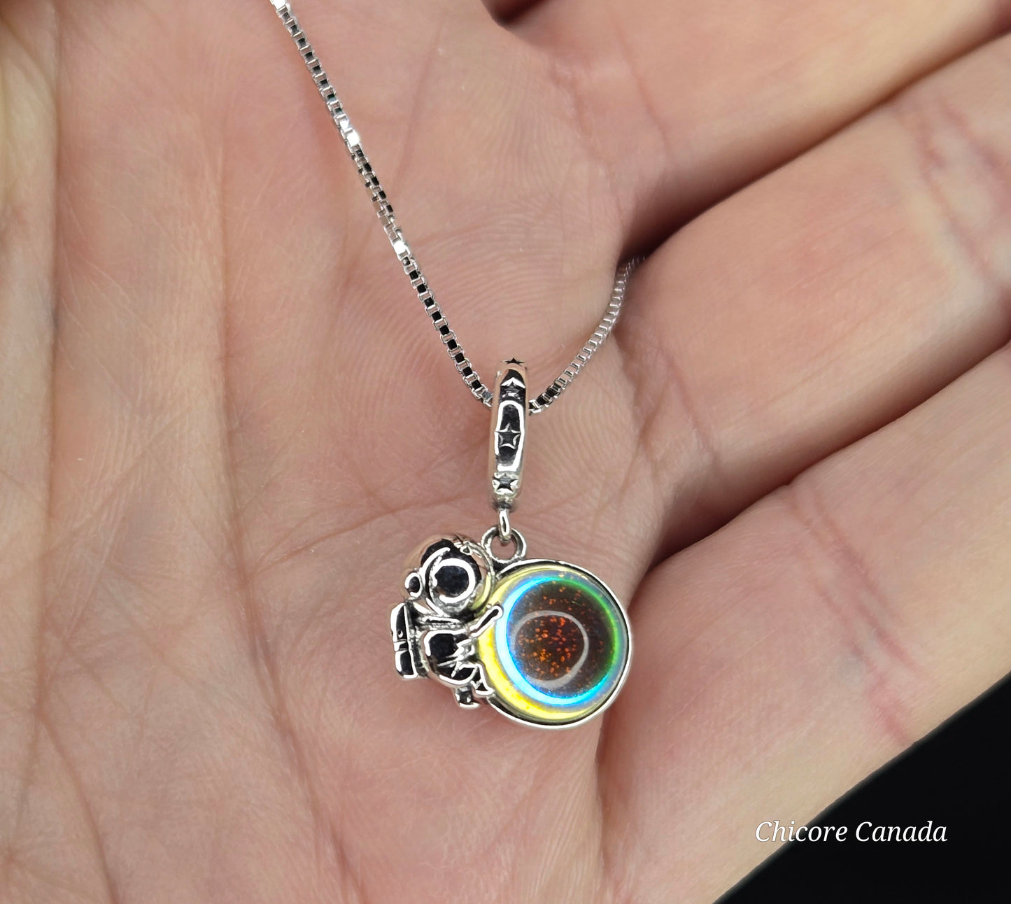 Celestial Voyager: Sterling Silver Astronaut Pendant with Luminous Moonstone